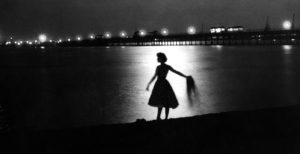 Woman silhouetted in the moonlight against the sea. 30 August 1958 ©TopFoto.co.uk