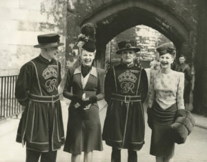 Tower of London, 1946, Yeoman Warders, C W Saunderson (left) and G J Trowbridge (middle), posing with two actresses from the film 'London Town', in front of the Byward Tower©Historic Royal Palaces