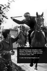 Police mounted on horseback attack Lesley Boulton from miners women's support group WAPC. Orgreave coke works mass picket, Miner's strike Sheffield South Yorkshire © John Harris/reportdigital.co.uk