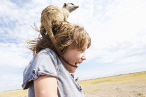 5 year old boy with Meerkat on his head, Kalahari Desert, Makgadikgadi Salt Pans, Botswana