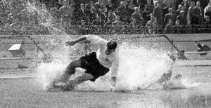 Preston North End's Tom Finney splashes through a puddle. Stamford Bridge 25.08.1956 ©John Horton/PA Archive