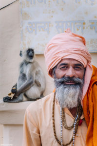 India, Rajasthan, Pushkar, Pushkar lake, Holi man with a monkey in the background in Pushkar ©Maurizio Rellini/4Corners Images