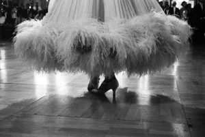 Feathers. Low angle view of a ballroom dancer's feathered hem. This photograph was featured in the exhibition 'The Ballroom Spy' in collaboration with artist Jack Vettriano which transferred from Heartbreak, London to the Royal West of England Academy in Bristol in 2011.