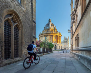 United Kingdom, England, Oxfordshire, Oxford, cyclist approaching Radcliffe Camera
