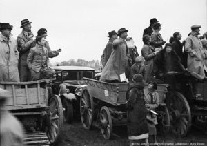 Race-goers caught up in the excitement of the moment. Date: circa 1930s